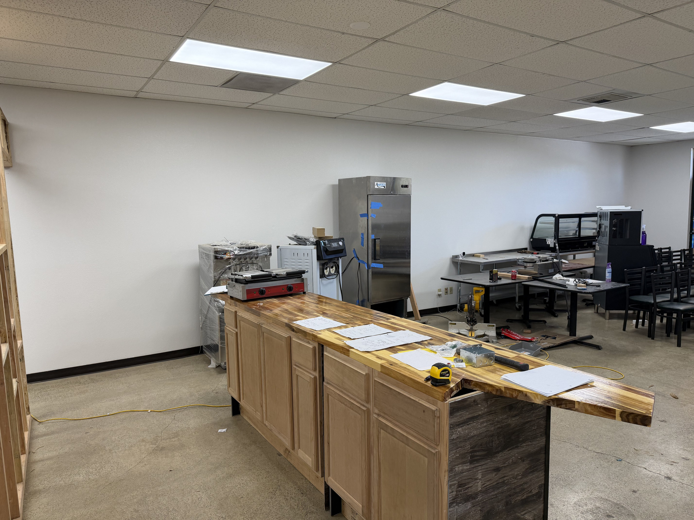 Wide view of the evolving commercial service area, countertop and food-service equipment.